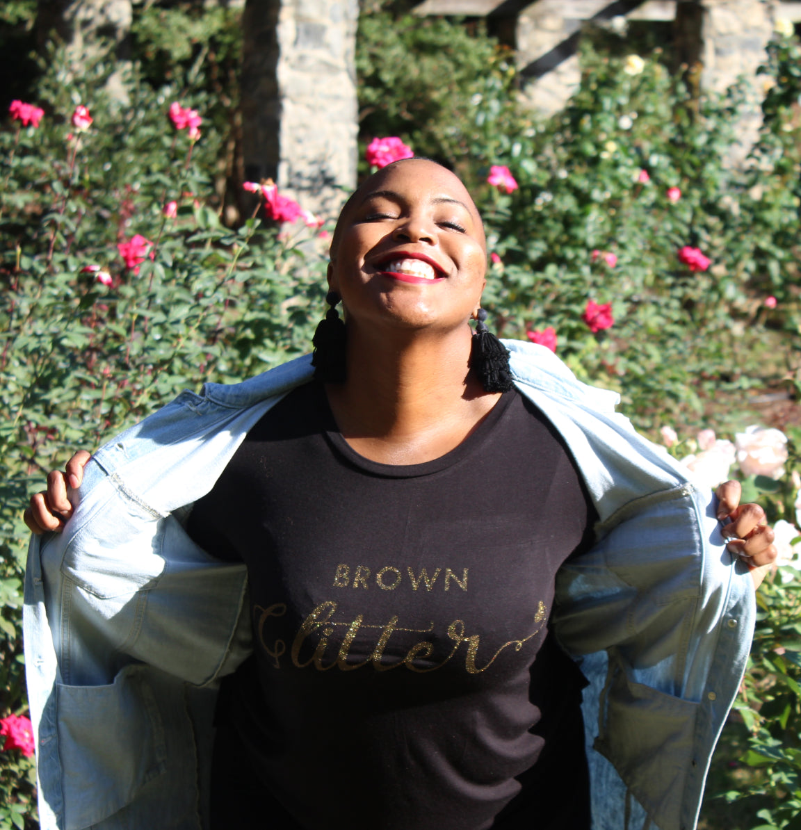 an image of the brown glitter founder wearing a branded shirt